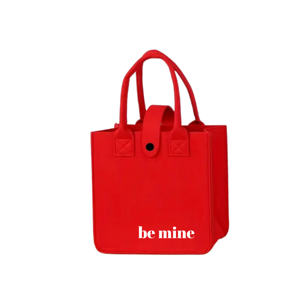 Be Mine Red Tote with white text and handles, featuring a button clasp. Ideal for personalized gifting, aligning with Celebratopia's custom gift offerings.