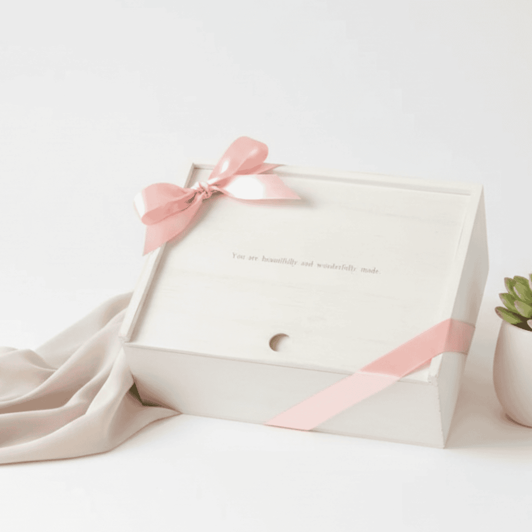 Gift box with pink ribbon and text on a white background