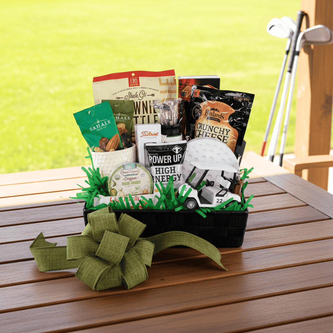 Golf themed gift basket with snacks on a wooden table with golf clubs in the background