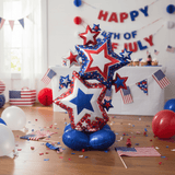 Decorative balloon with stars with July 4th decorations in the background.