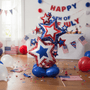 Decorative balloon with stars with July 4th decorations in the background.