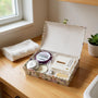 Gift box with lavender bath products on a wooden surface near a window