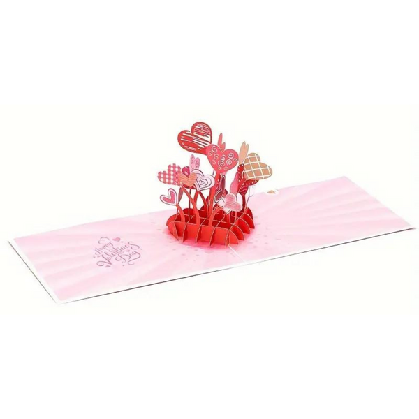 Love You More Pop Up Card featuring a heart design, crafted from recycled paper, includes a blank note for your message. Perfect for expressing affection.