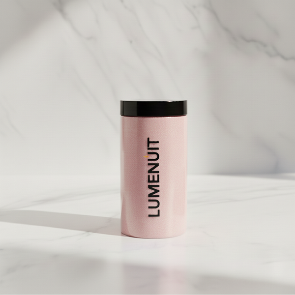 Pink canister labeled “LUMENUT.” containing Lumenuit Colored Wax Pearls for customizable, eco-friendly candle-making, featuring black lid, on white marble surface.