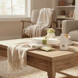 Wooden coffee table with mindful gift items in a living room setting