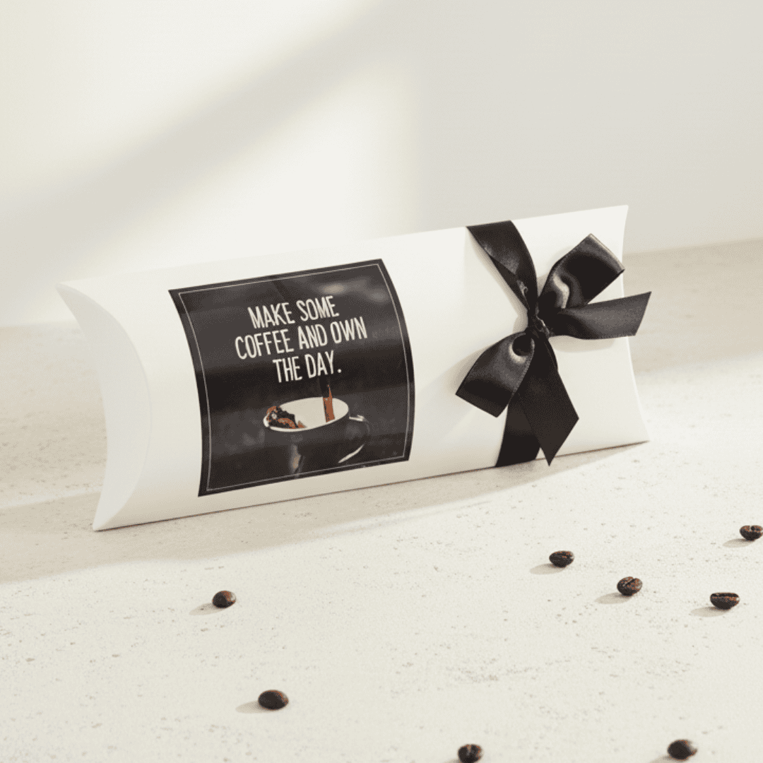 Decorative pillow with a black bow and coffee-themed design on a light surface.