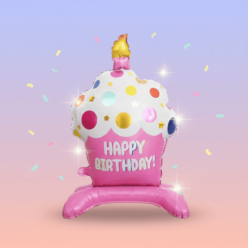 a jumbo pink cupcake birthday balloon with white frosting on a gradient background with confetti