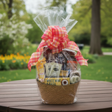 Gift basket with a plaid bow on a wooden table outdoors