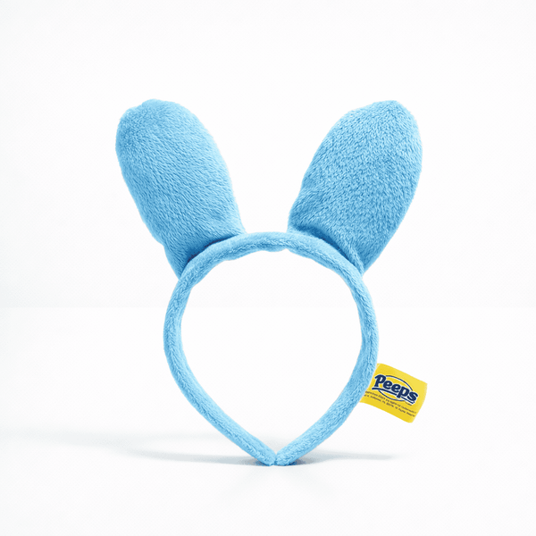 Peeps Bunny Ears - Blue: Light-blue plush headband with bunny ears, featuring a Peeps logo tag, perfect for themed gifts from Celebratopia.