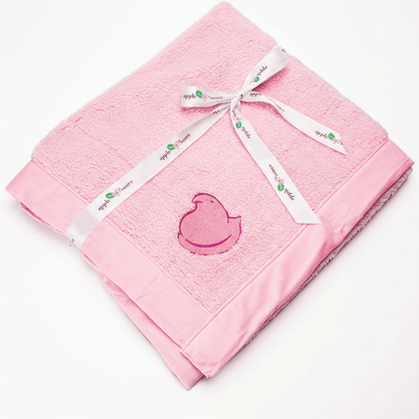 Peeps Chick Whisper Baby Blanket - Pink, folded with a branded ribbon, featuring an embroidered chick design. Soft, fluffy exterior and velvet interior, 30x36.