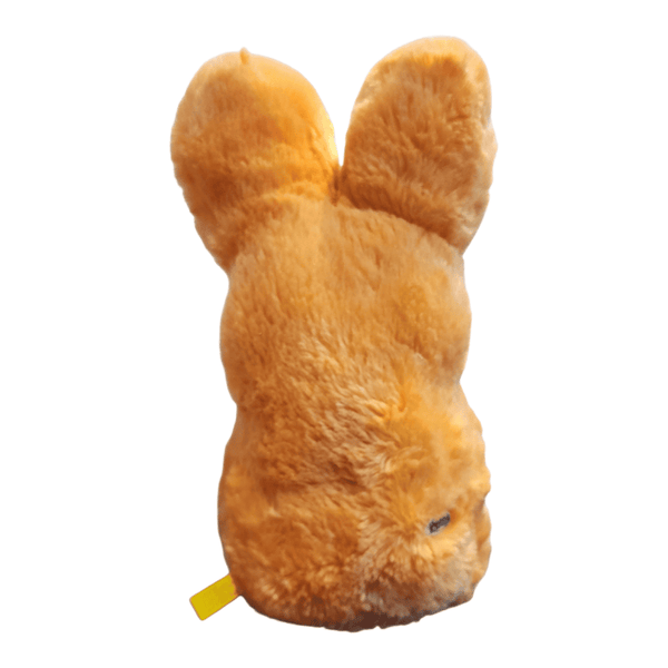 Peeps Plush Shaggy Bunny - 16 Orange, featuring long ears and fuzzy fur, showcasing the back view with a Peeps emblem and fabric tag visible.